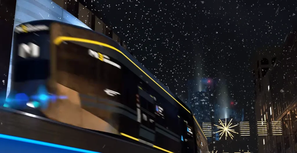 Train speeding through snowy city street at night