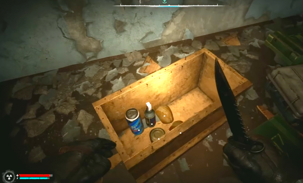 First-person view looting wooden crate in ruined room
