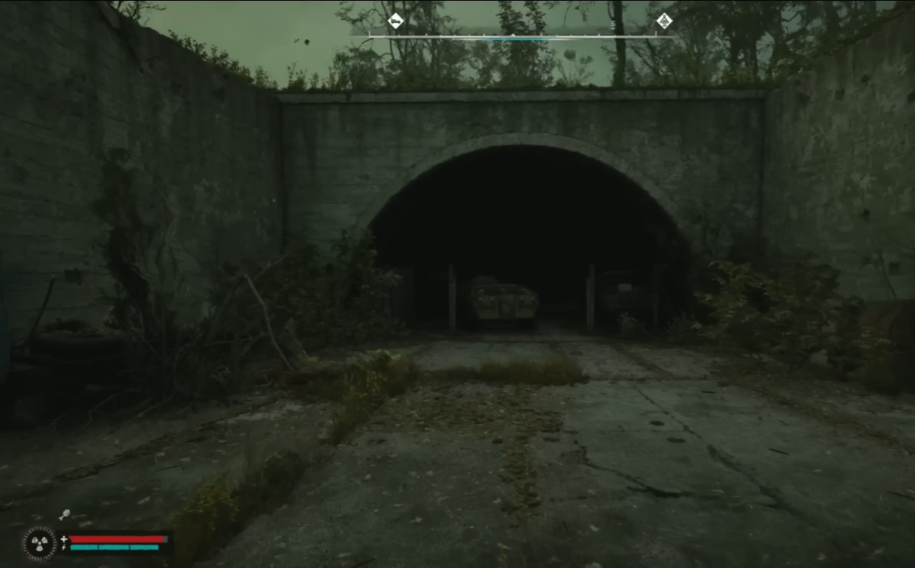 Abandoned tunnel entrance in overgrown concrete area
