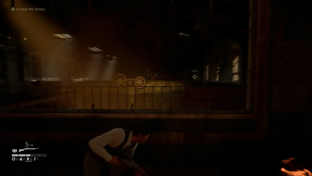 Man crouches with rifle inside dark factory building