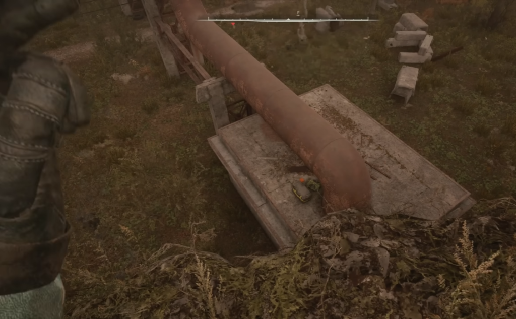 Gloved hand holding grenade near rusty pipe