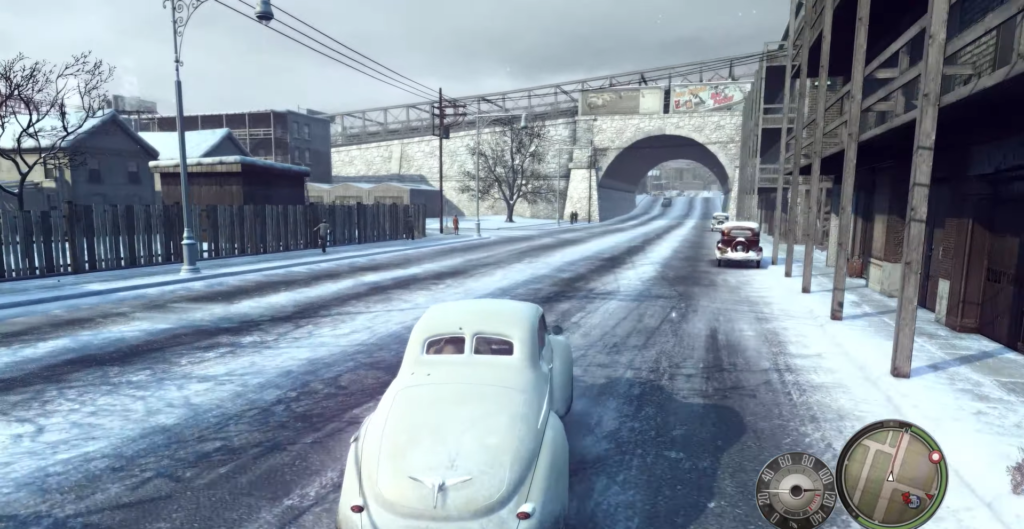 Vintage white car on snowy street.