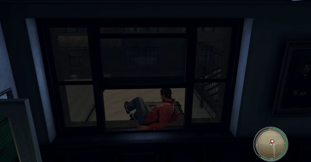 Man in red hoodie sitting window.