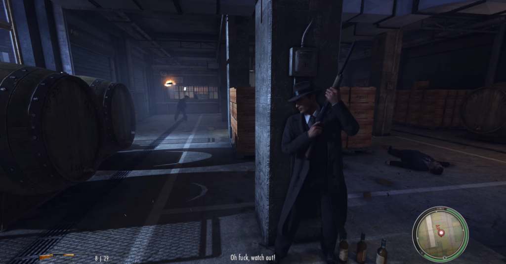 Man in suit aiming shotgun warehouse.
