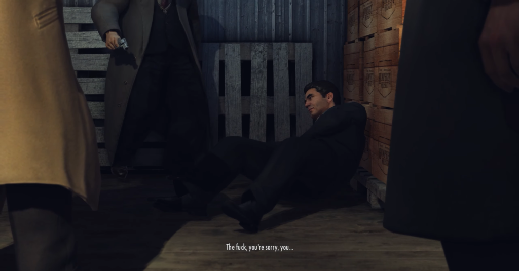 Man sitting against wooden crates, pleading.
