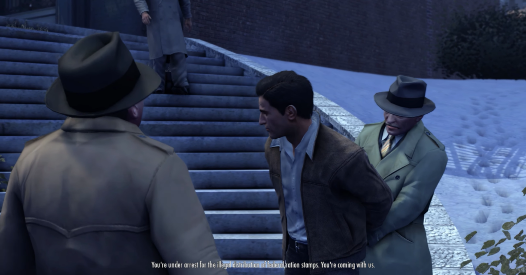 Man handcuffed, two men in suits.