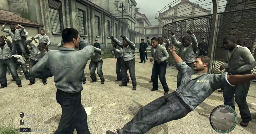Prisoners fighting in gray uniforms outdoors.