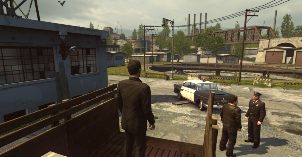 Man in suit overlooking police car.