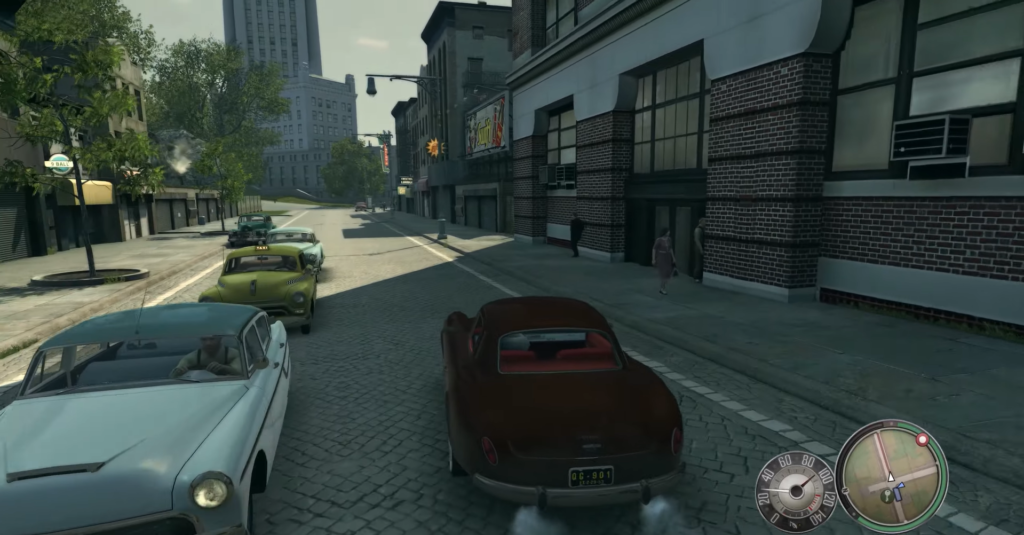 Classic cars driving on cobblestone street.