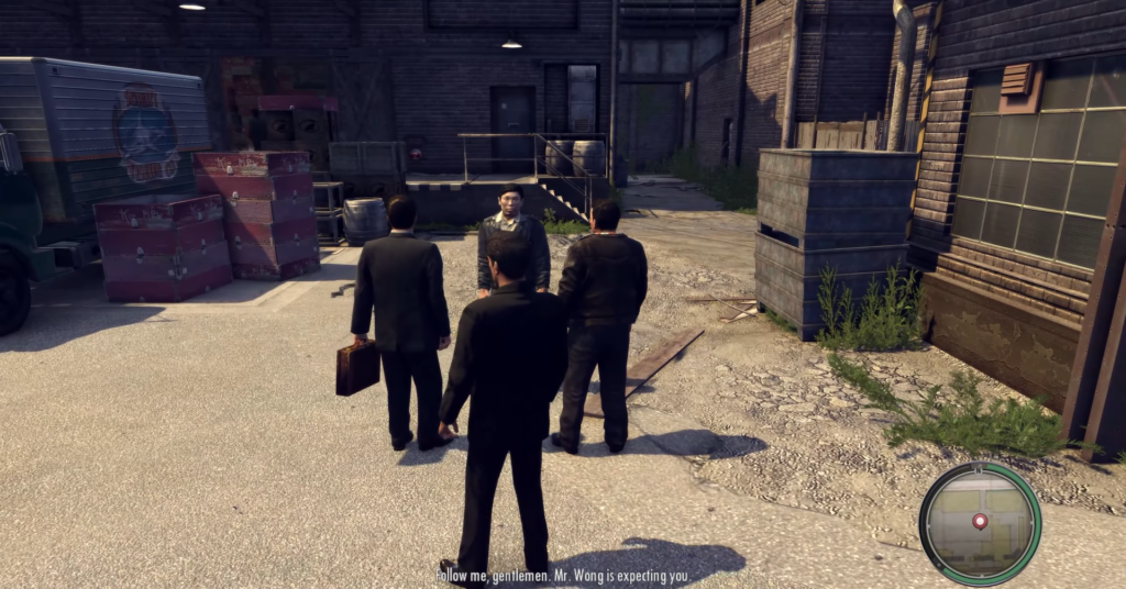 Men in suits meeting near warehouse.