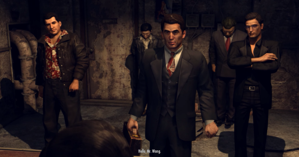 Men in suits inside dimly lit room.