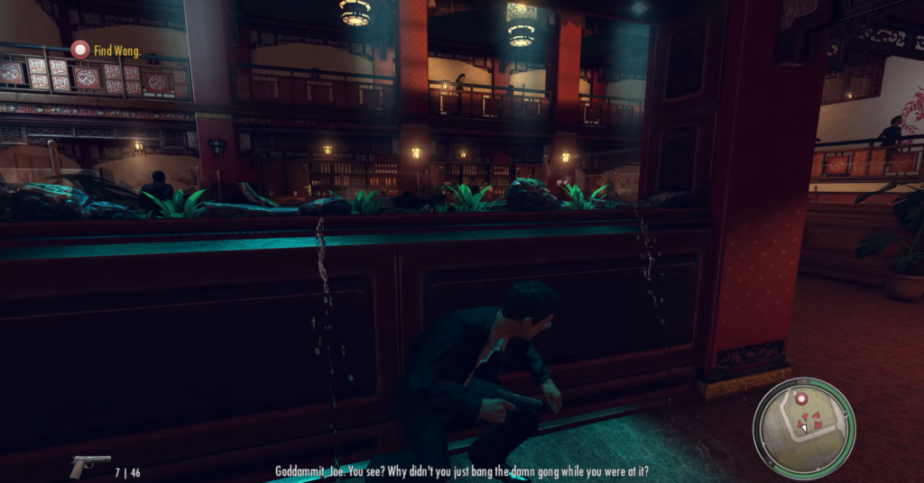 Man crouching behind wooden bar, gun.