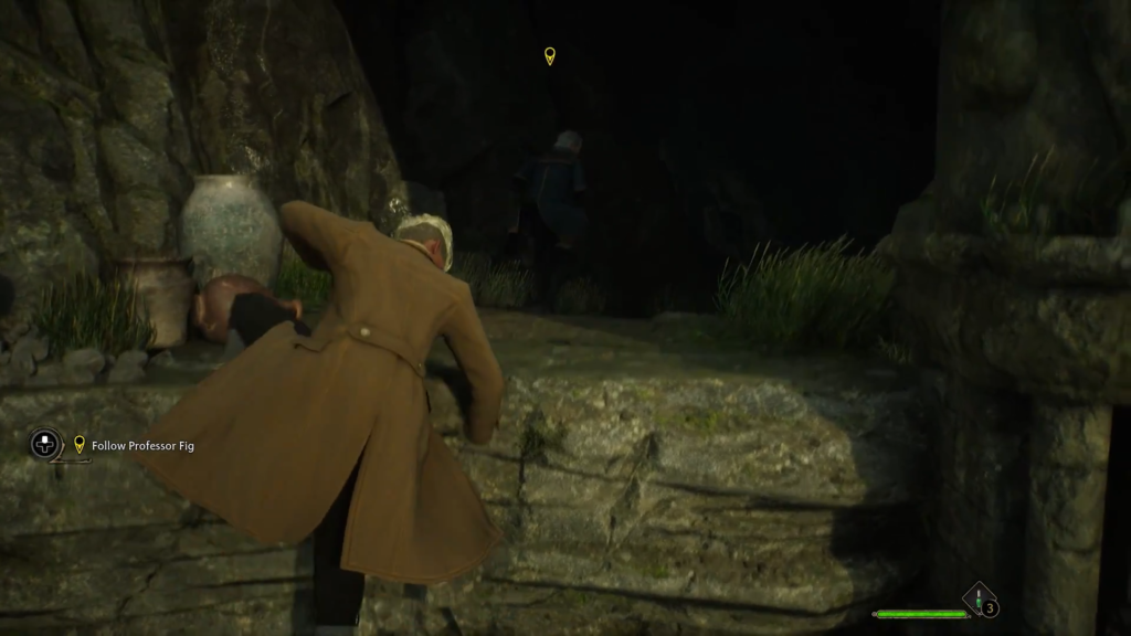 Man in brown coat climbing rocky ledge.