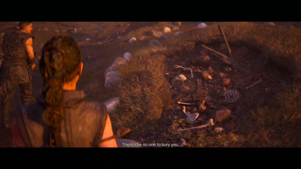 Two people look at bones in grassy field