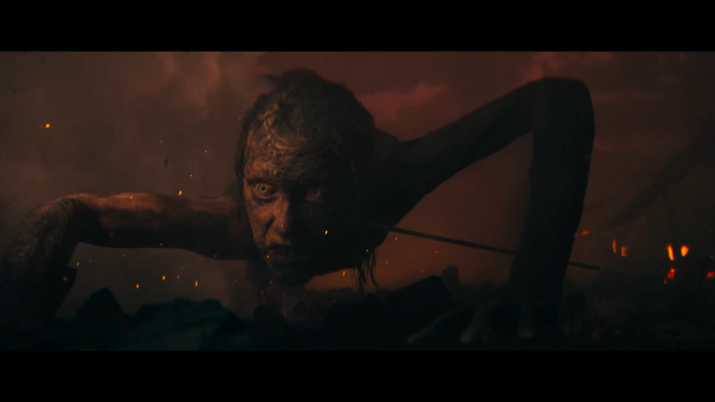 Scarred humanoid crawling through smoky fire-lit ruins