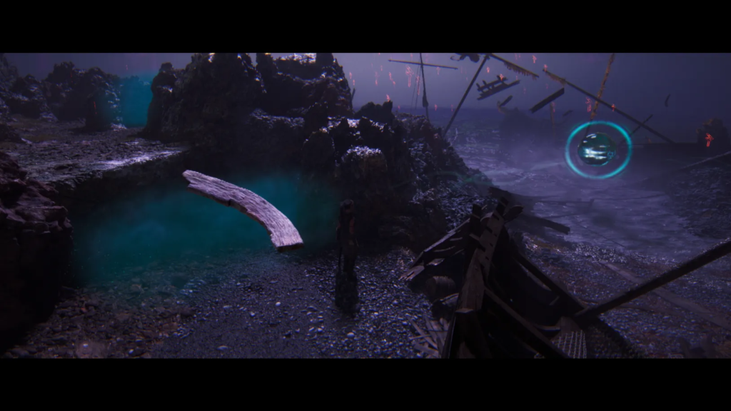Person walking on rocky shore near shipwreck debris
