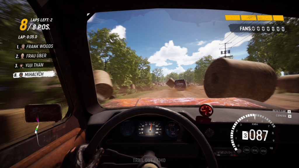 Trail Out driver racing on dirt track past hay bales