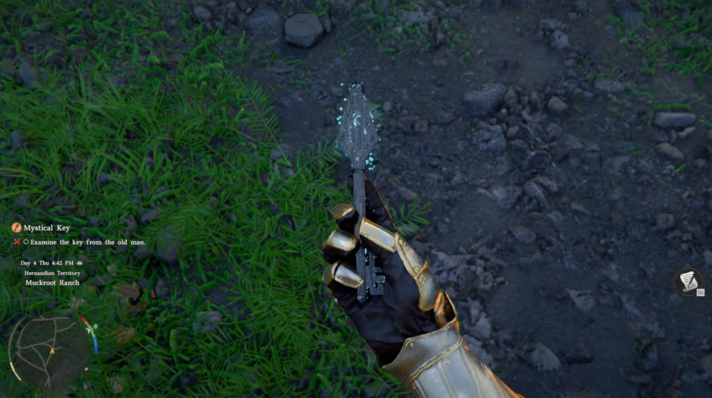 Gloved hand holds mystical key over rocky ground