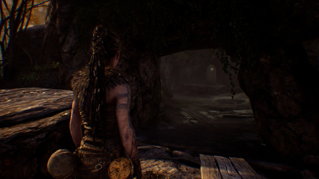 Senua walking through cave tunnel in Hellblade: Senua's Sacrifice