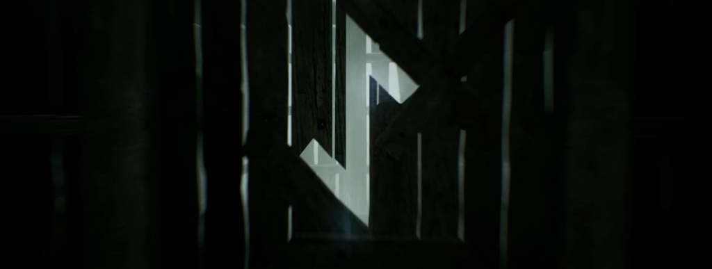 Light shining through wooden slats in dark room