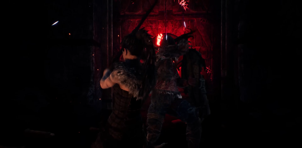 Senua fights enemy in red-lit stone corridor