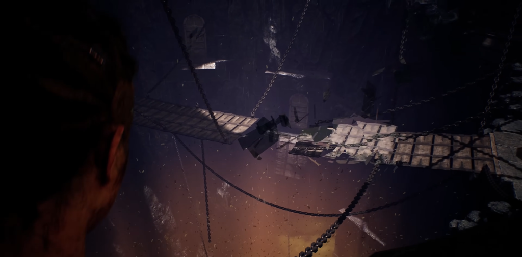 Person watching broken wooden bridge in dark cavern
