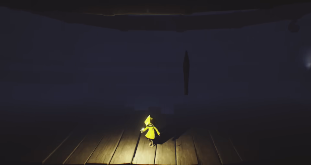 Six in yellow raincoat holding lighter on wooden floor