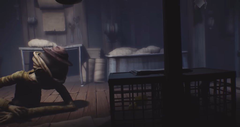 Six crawling on wooden floor in Little Nightmares room