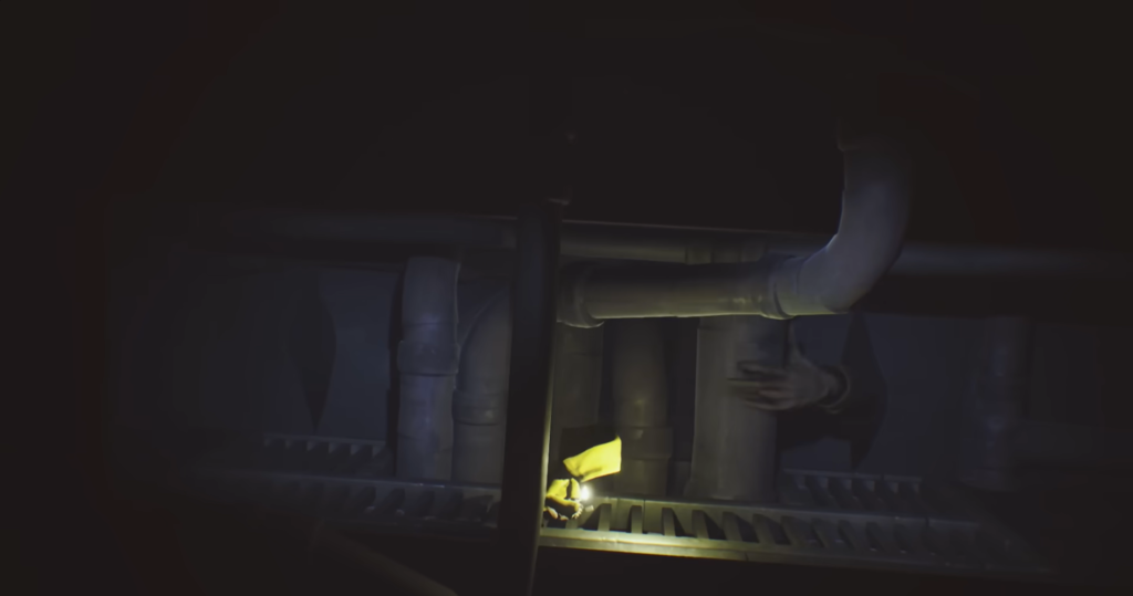 Yellow-hooded figure crawls through dark pipe tunnel