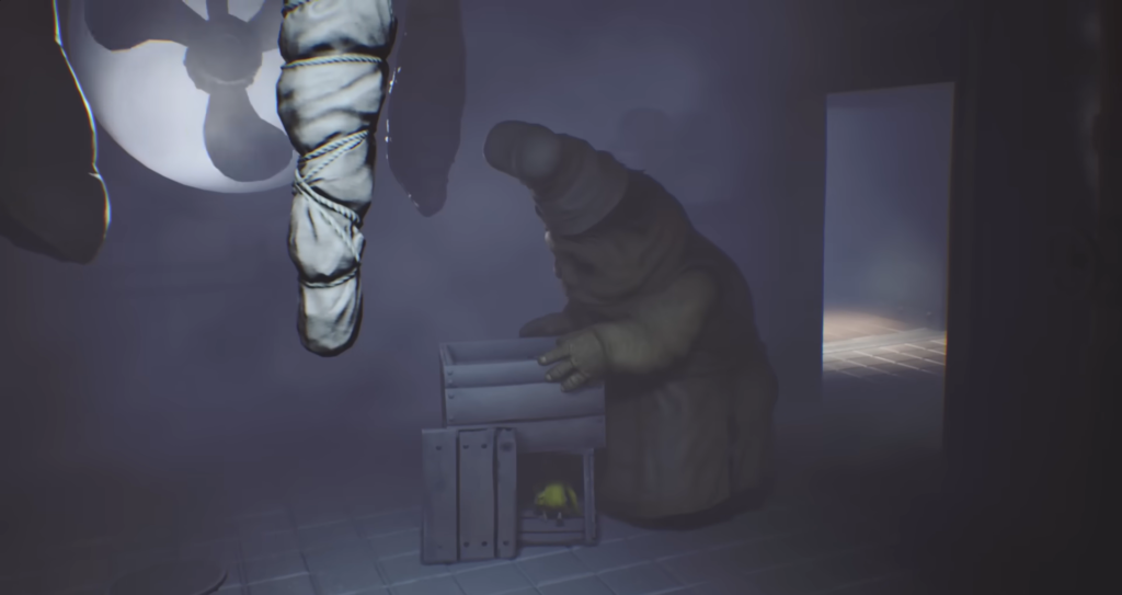 Little Nightmares Janitor reaching into crate in hallway