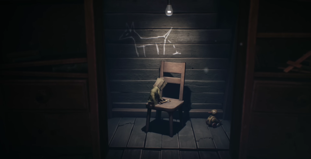 Gloved hand on chair in dark wooden room