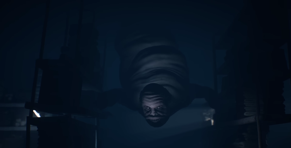 Man hanging upside down in dark room