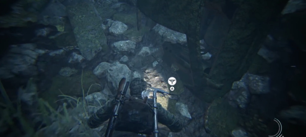 Player character crawling through rocky crevice in game