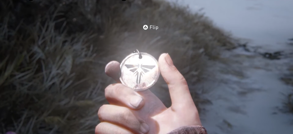 Hand holding Firefly pendant near riverbank grass