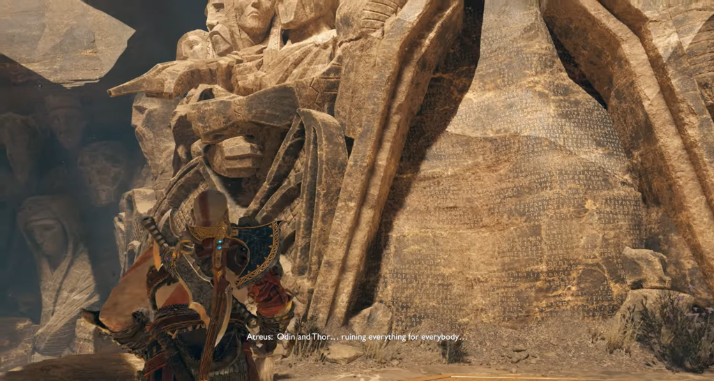 Atreus stands before carved stone statues in God of War