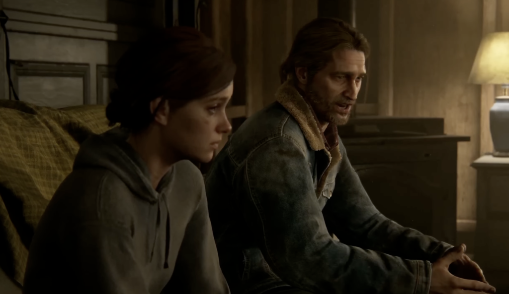 Ellie and Joel sit on couch indoors, The Last of Us