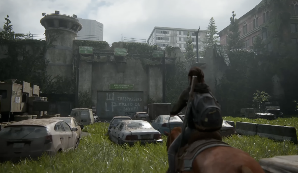 Ellie rides horse toward quarantine wall in The Last of Us
