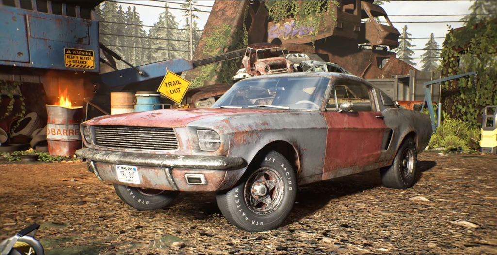 Rusty red and gray car parked in scrapyard