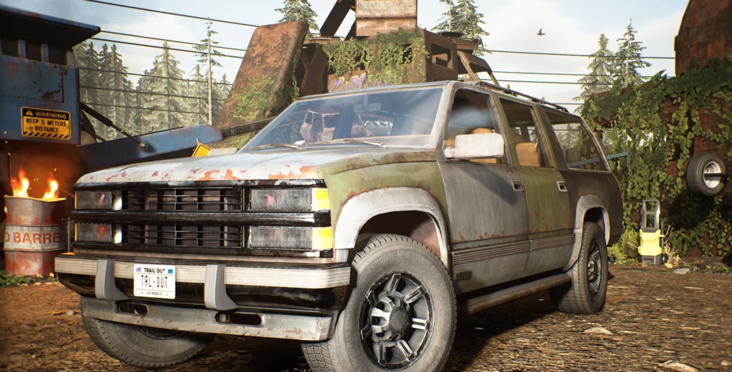 Rusty SUV parked in scrapyard with burning barrel