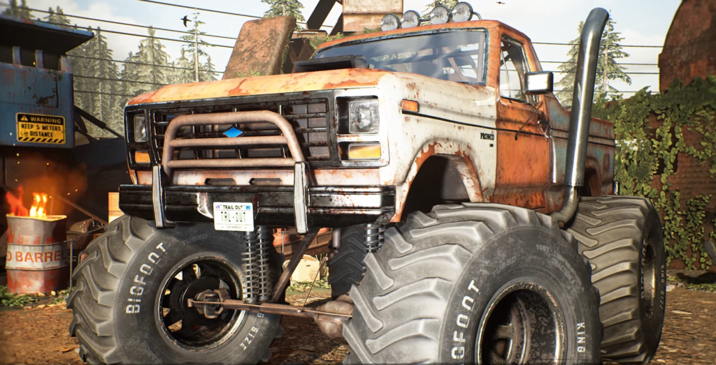 Orange and white monster truck parked in scrapyard