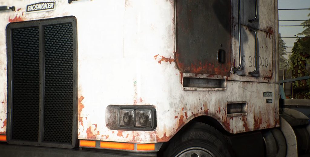 White semi truck cab parked outdoors near trees