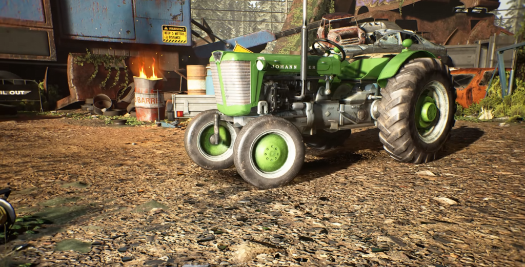 Green tractor parked in scrapyard near burning barrel