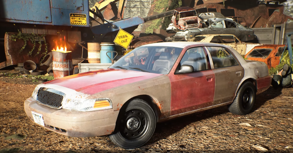 Red and beige sedan parked in junkyard scrapyard
