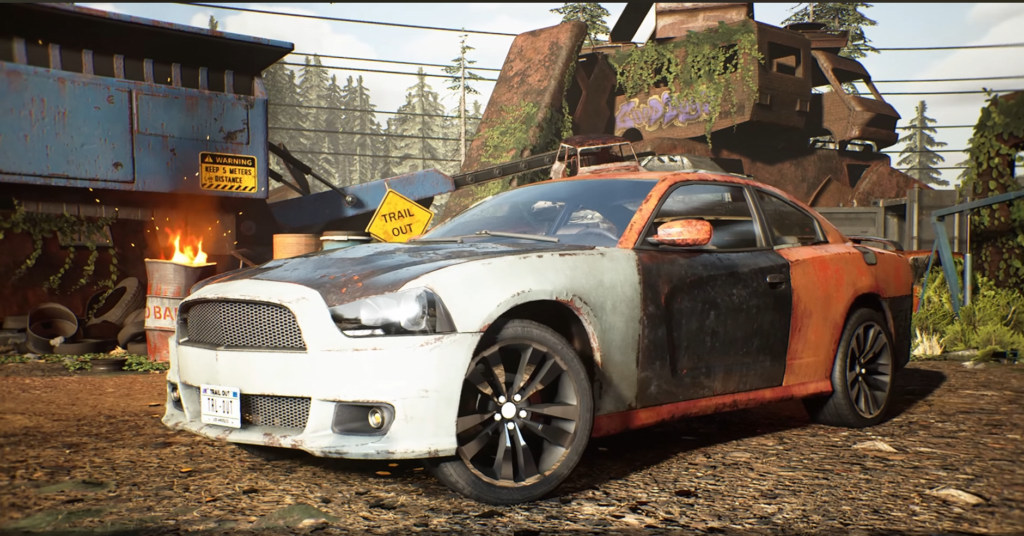 Rusty black and orange car parked in scrapyard