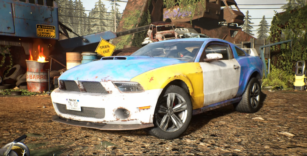 Blue and yellow car parked in scrapyard