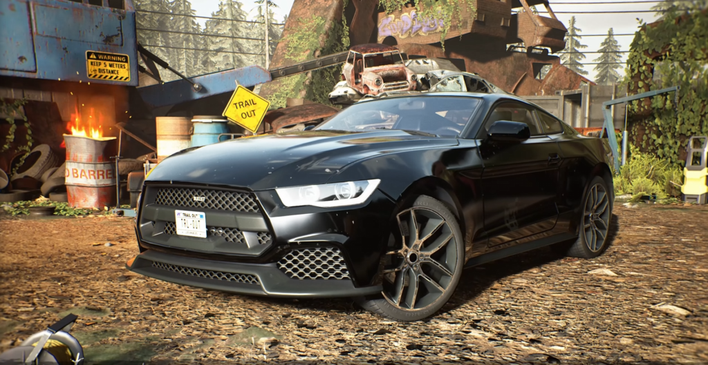 Black sports car parked in scrapyard with wrecks