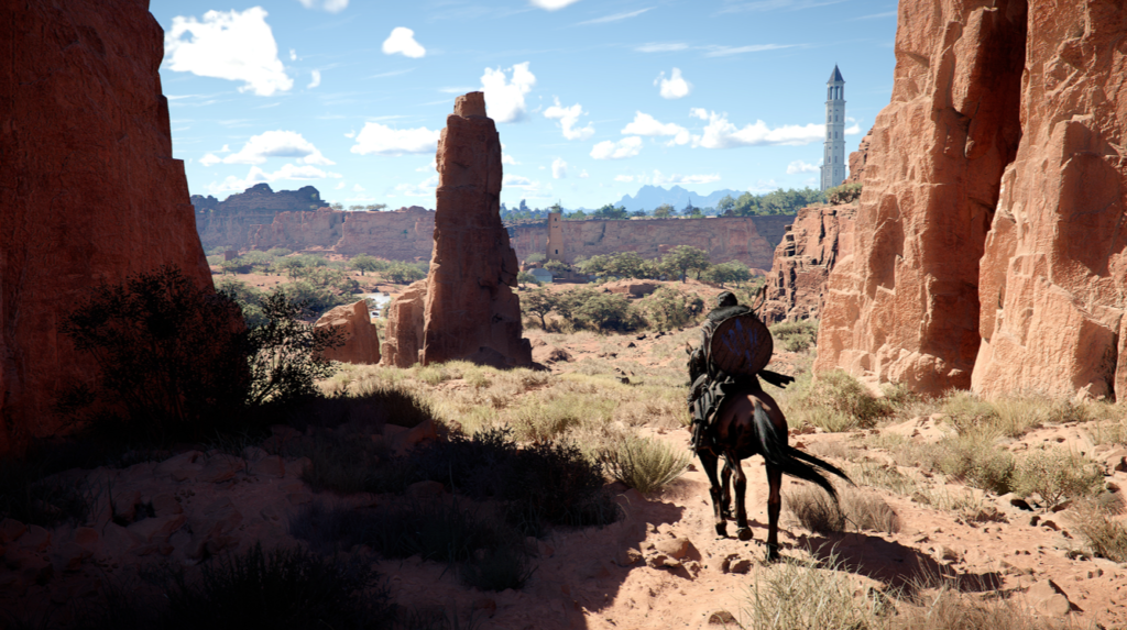 Rider on horseback travels through red rock canyon