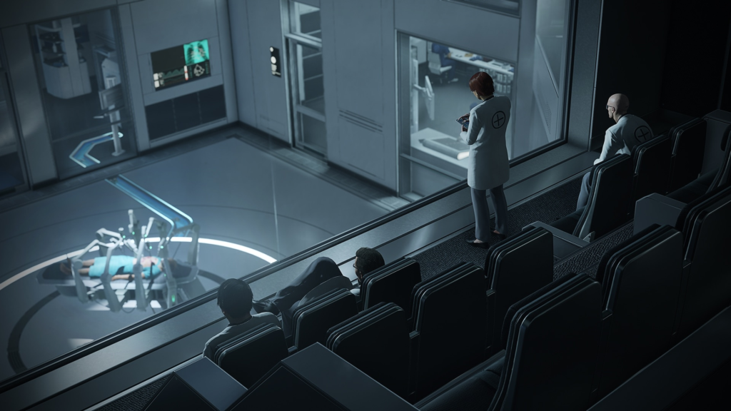 Scientists observe patient on table in lab auditorium