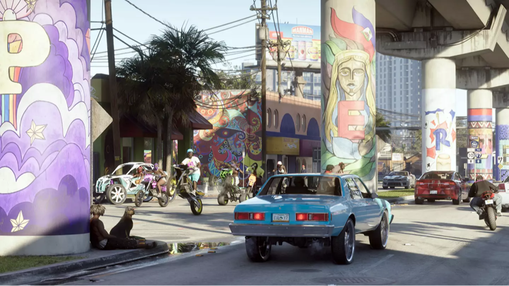 Blue car driving past bikers under graffiti overpass