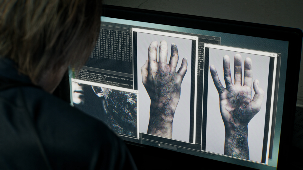 Person viewing hand scan images on computer monitor